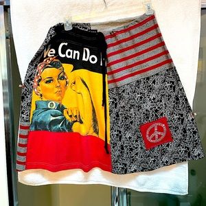 Hand crafted skirt with We Can Do It graphic and rhinestone peace sign.